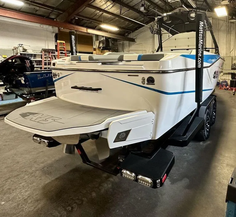 Slide: The Image of 2024 Axis T250 boat in a warehouse, rear view with swim platform. - 2