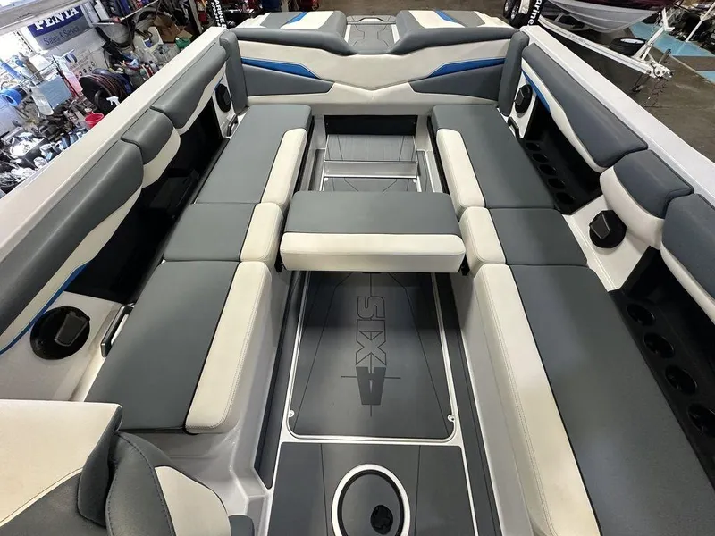 Slide: The Image of 2024 Axis T250 boat interior with gray and white seating, blue accents, and spacious layout. - 3