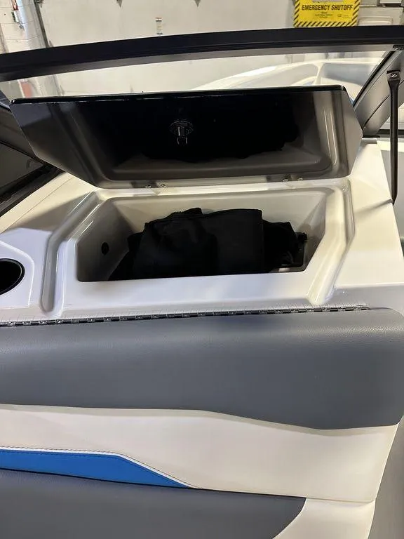 Slide: The Image of 2024 Axis T250 boat storage compartment with open lid, showcasing interior space. - 6