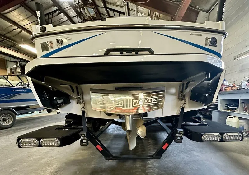 Slide: The Image of 2024 Axis T250 boat rear view in a workshop setting. - 7
