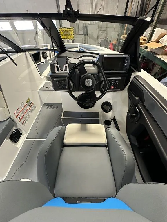 Slide: The Image of 2024 Axis T250 boat interior with steering wheel and dashboard controls. - 8