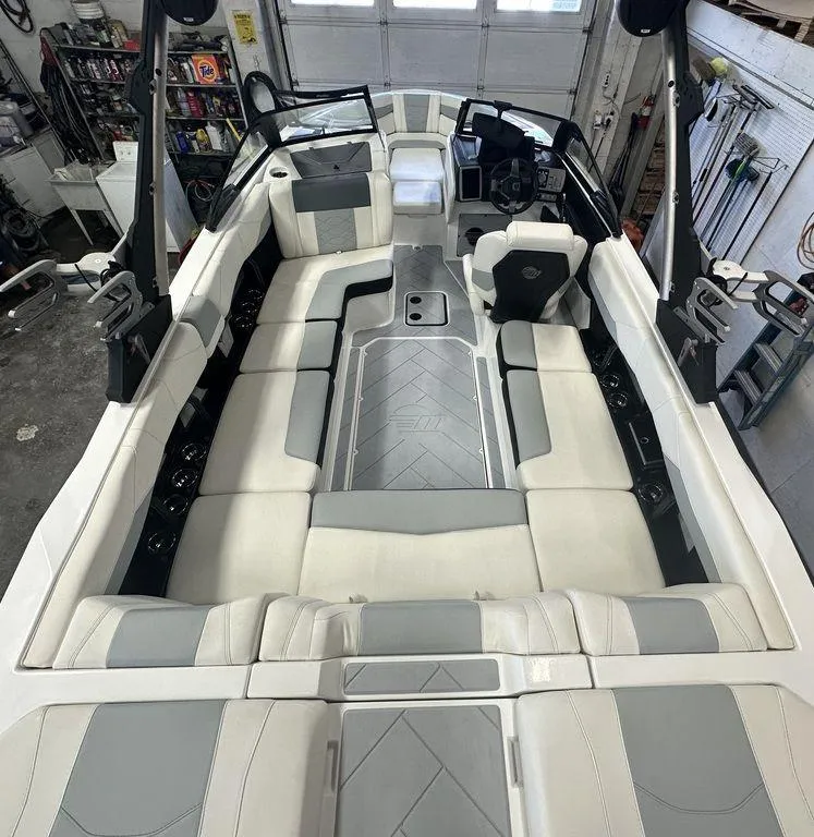 Slide: The Image of 2024 Malibu 23 LSV boat interior with spacious seating and modern design. - 10