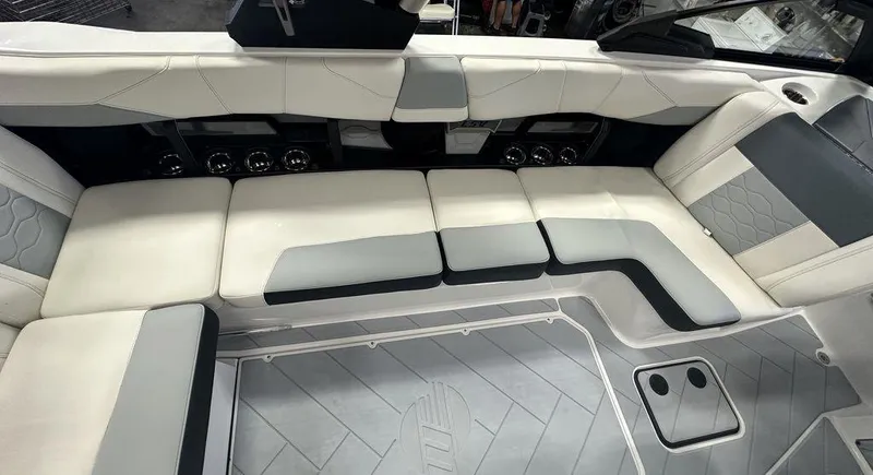Slide: The Image of 2024 Malibu 23 LSV boat interior with white and gray seating. - 11