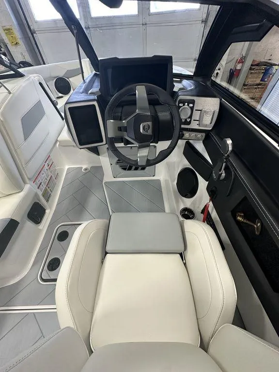 Slide: The Image of 2024 Malibu 23 LSV boat interior with modern dashboard and steering wheel. - 15