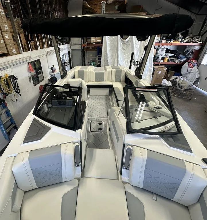 Slide: The Image of 2024 Malibu 23 LSV boat interior with sleek seating and modern design. - 20