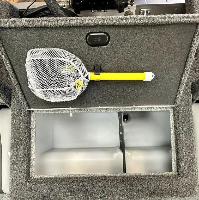 Slide: The Image of 2024 Lund 1775 Impact XS Sport storage compartment with a yellow-handled net. - 4