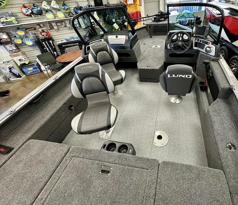 Slide: The Image of 2024 Lund 1775 Impact XS Sport boat interior with seating and control console. - 5