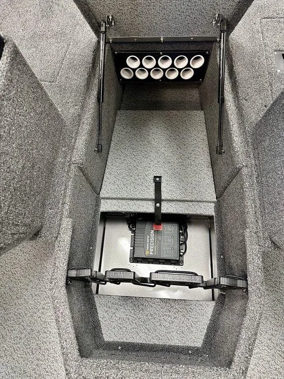 Slide: The Image of 2024 Lund 1775 Impact XS Sport interior storage compartment with rod holders. - 6