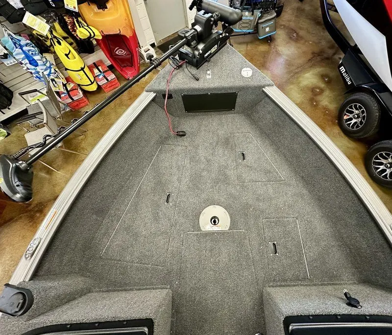 Slide: The Image of 2024 Lund 1775 Impact XS Sport boat interior with trolling motor in showroom. - 9