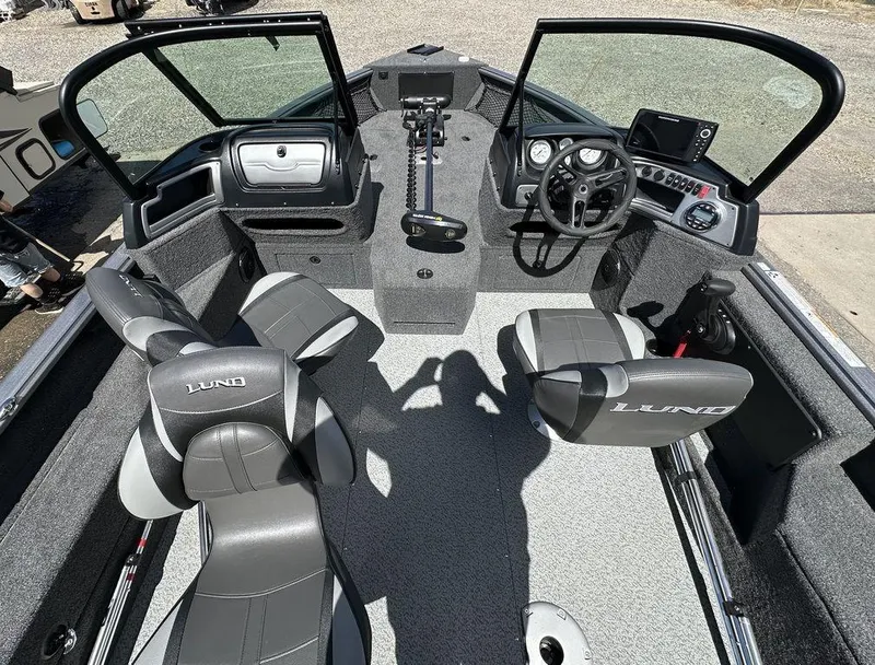 Slide: The Image of 2024 Lund 1875 Impact XS Sport boat interior with seating and control console. - 5
