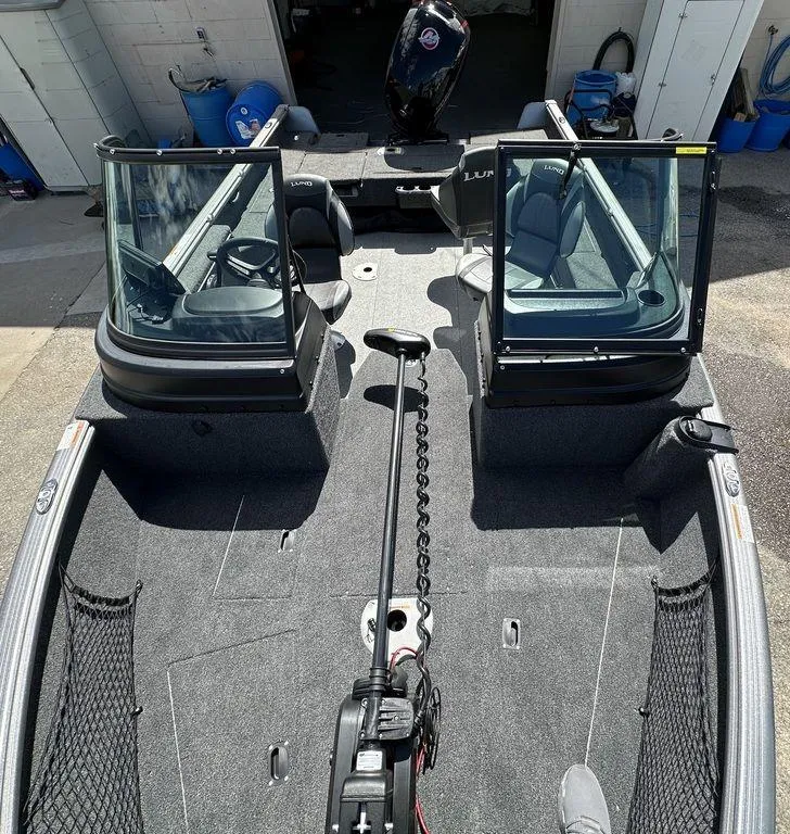 Slide: The Image of 2024 Lund 1875 Impact XS Sport fishing boat interior with open windshield. - 8