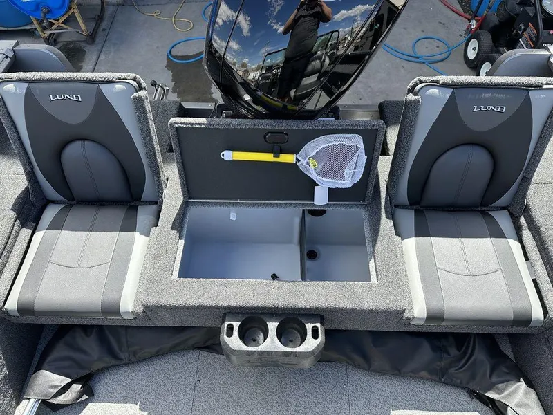 Slide: The Image of 2024 Lund 1875 Impact XS Sport boat interior with storage and seating. - 9
