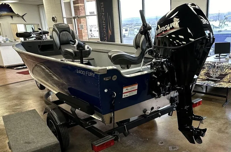 Slide: The Image of 2024 Lund 1400 Fury Tiller boat with Mercury outboard motor in showroom. - 3
