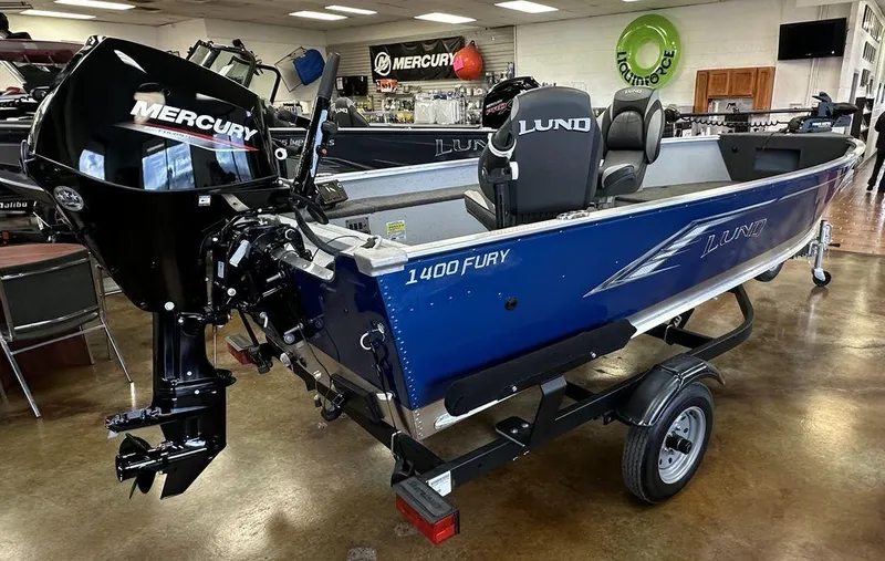 Slide: The Image of 2024 Lund 1400 Fury Tiller boat with Mercury outboard motor in showroom. - 4