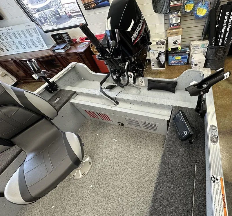 Slide: The Image of 2024 Lund 1400 Fury Tiller boat interior with Mercury outboard motor. - 8