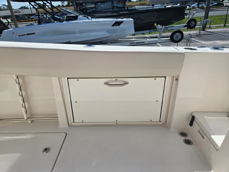 Slide: The Image of 2024 Sailfish 312CC boat interior with storage compartment. - 13