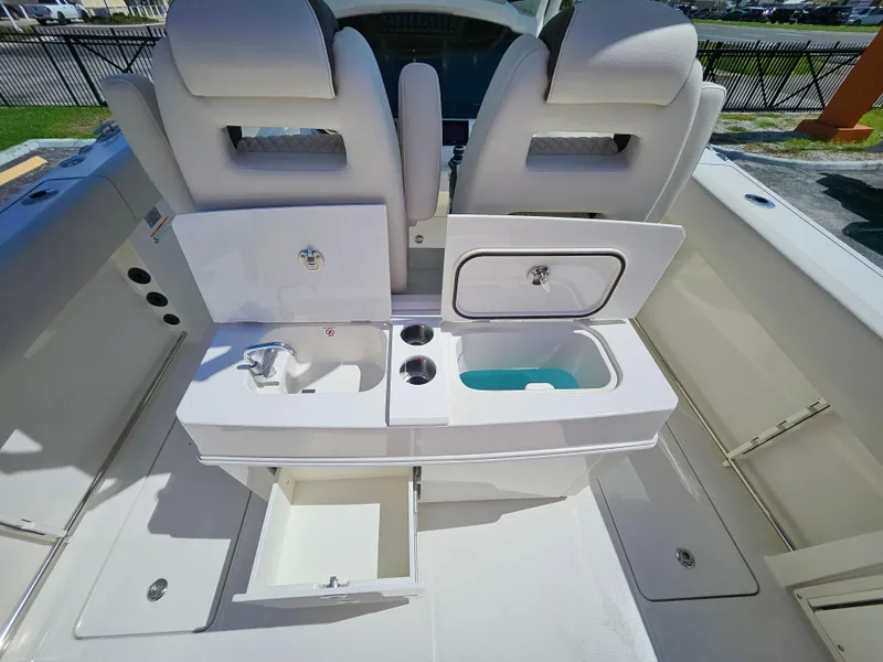 Slide: The Image of 2024 Sailfish 312CC boat interior with dual seats and storage compartments. - 15