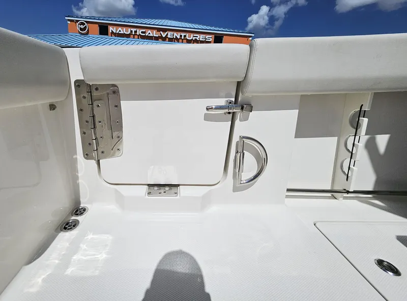 Slide: The Image of 2024 Sailfish 312CC boat interior with white seating and stainless steel hardware. - 16