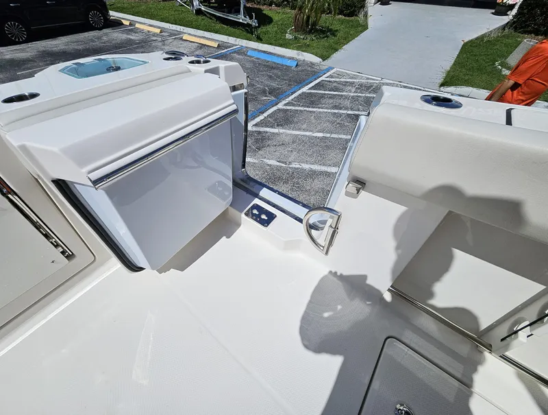 Slide: The Image of 2024 Sailfish 312CC boat deck with storage compartments and seating. - 17
