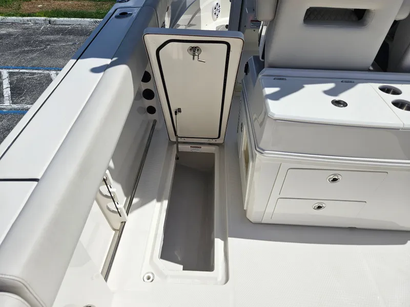 Slide: The Image of 2024 Sailfish 312CC boat storage compartment and seating area. - 18