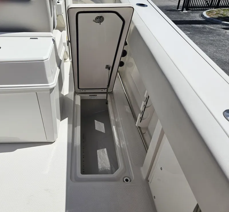 Slide: The Image of 2024 Sailfish 312CC boat storage compartment with open hatch. - 19