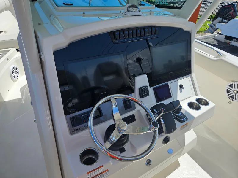 Slide: The Image of 2024 Sailfish 312CC boat helm with modern controls and dual displays. - 24