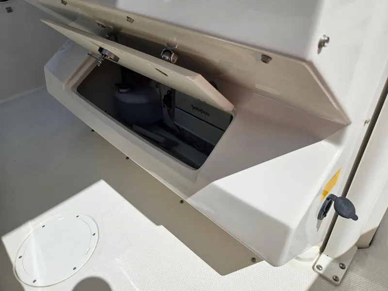 Slide: The Image of 2024 Sailfish 312CC storage compartment with open hatch. - 29