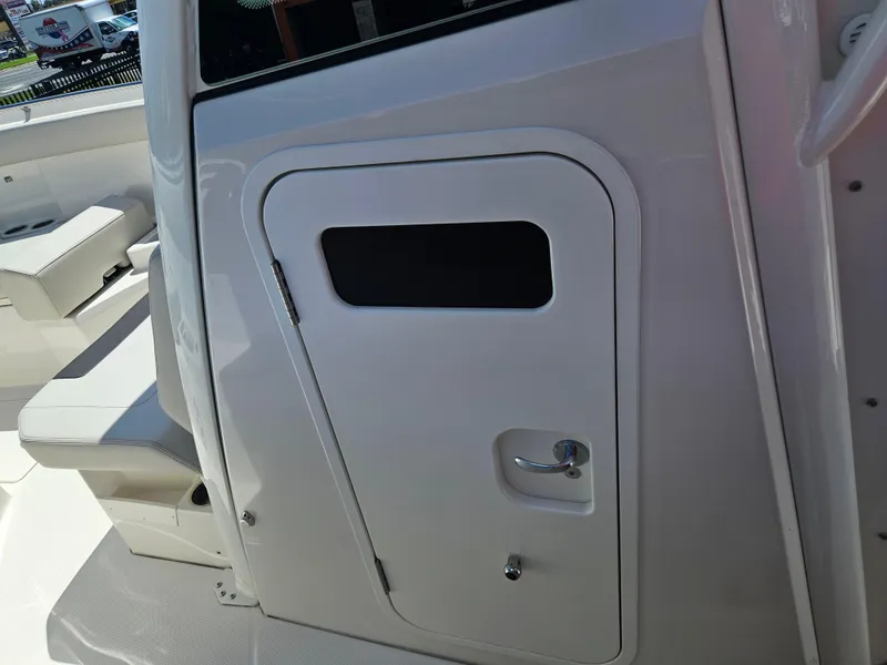 Slide: The Image of 2024 Sailfish 312CC boat interior door and seating area. - 30