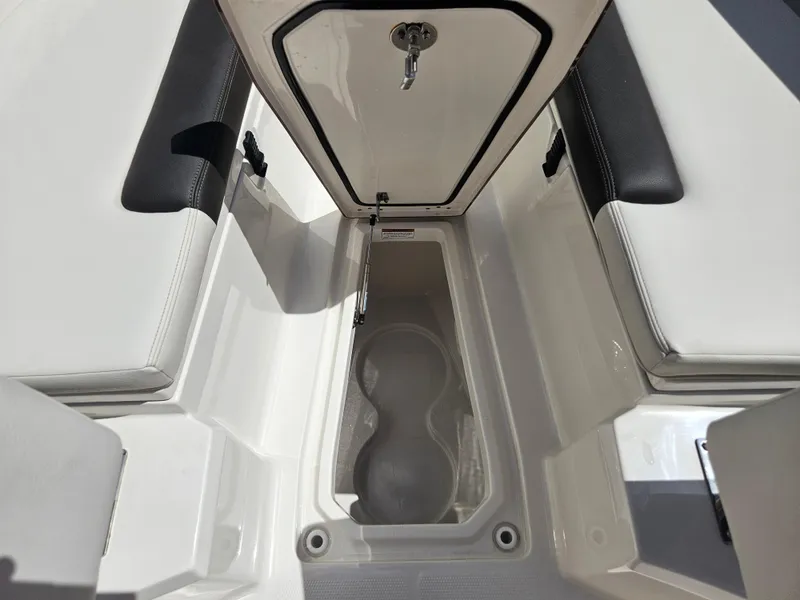 Slide: The Image of 2024 Sailfish 312CC boat storage compartment with cushioned seating. - 37