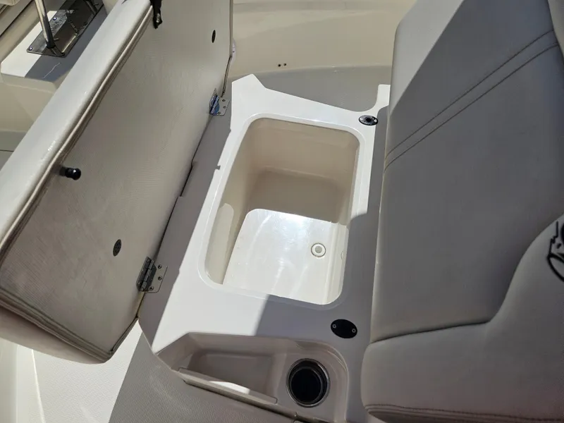 Slide: The Image of 2024 Sailfish 312CC boat with open storage compartment under seat. - 39