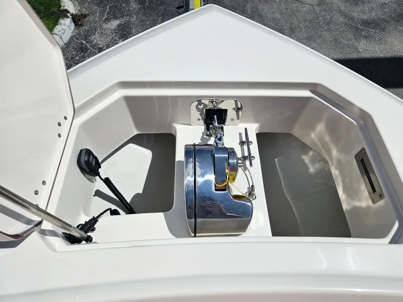 Slide: The Image of 2024 Sailfish 312CC boat anchor compartment with winch and storage. - 40