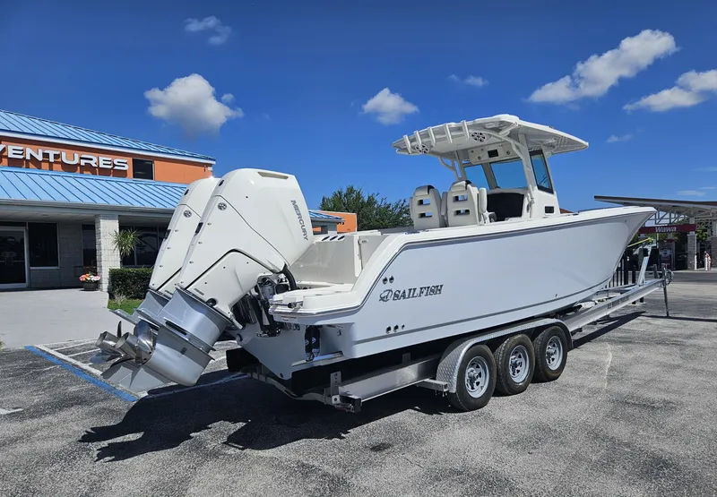 Slide: The Image of 2024 Sailfish 312CC boat on a trailer outside a dealership. - 5