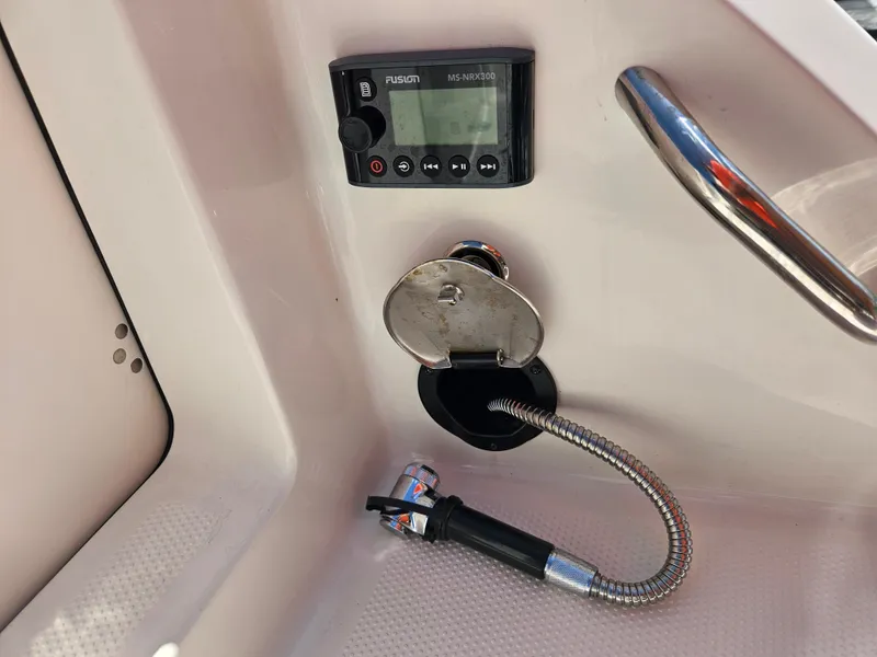 Slide: The Image of 2024 Sailfish 312CC boat console with Fusion MS-NRX300 radio and hose. - 6