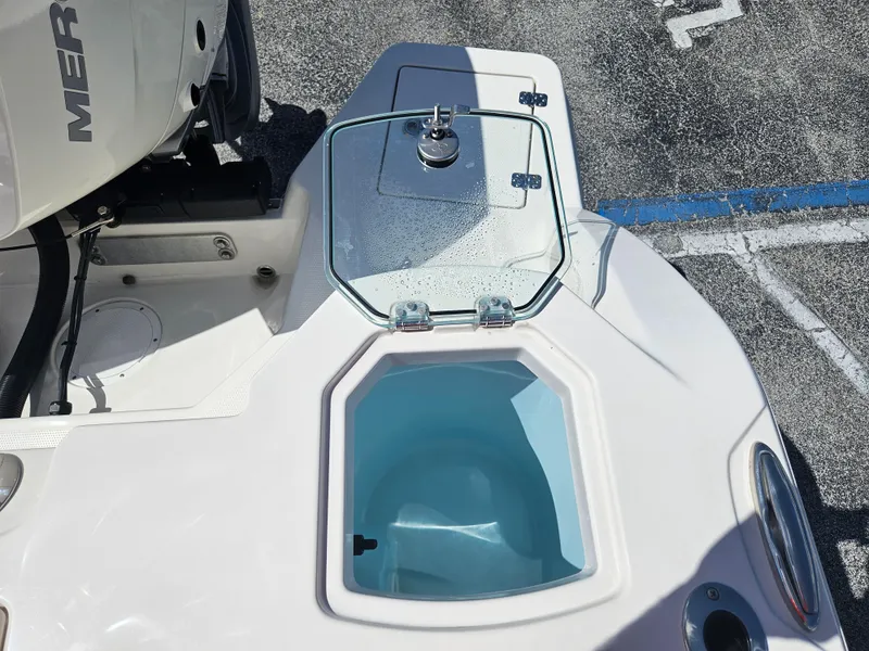 Slide: The Image of 2024 Sailfish 312CC boat with open livewell and engine detail. - 7