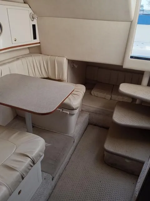 Slide: The Image of Interior of 2001 Sea Ray 290 Amberjack with dining area and steps. - 10