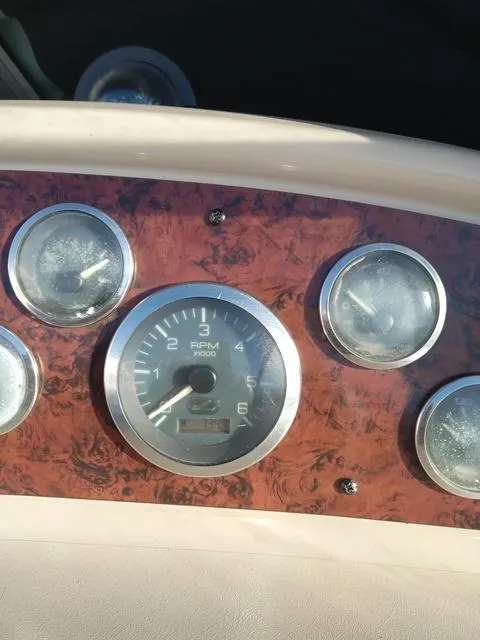 Slide: The Image of Dashboard of a 2001 Sea Ray 290 Amberjack boat with RPM gauge. - 14