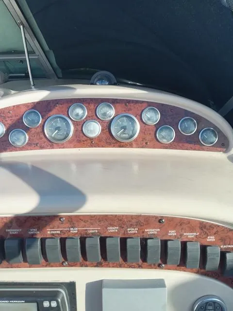 Slide: The Image of Dashboard of a 2001 Sea Ray 290 Amberjack boat with gauges and switches. - 15