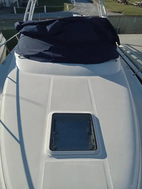 Slide: The Image of 2001 Sea Ray 290 Amberjack boat deck with hatch and blue cover. - 17