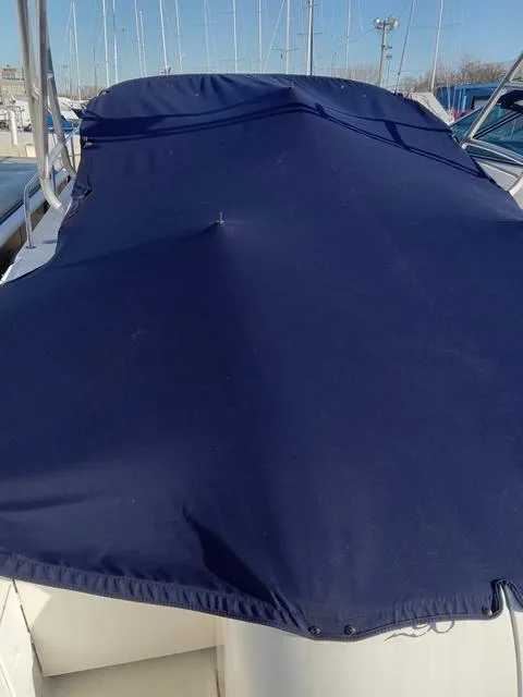 Slide: The Image of 2001 Sea Ray 290 Amberjack boat with blue cover in marina. - 18