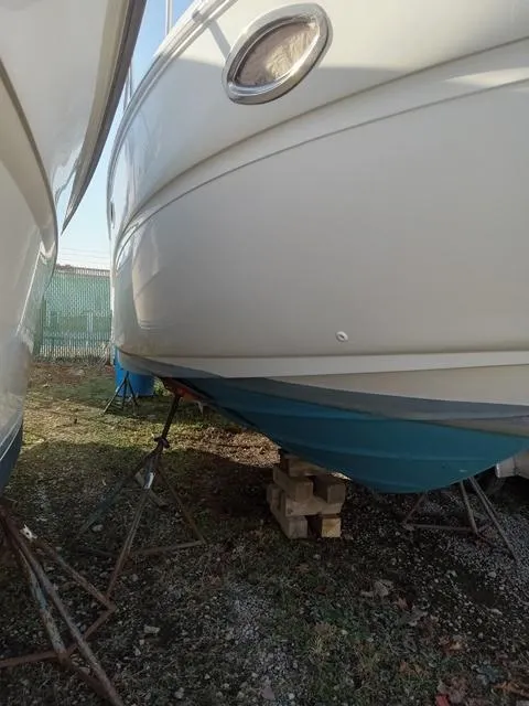 Slide: The Image of 2001 Sea Ray 290 Amberjack boat on stands for maintenance. - 2