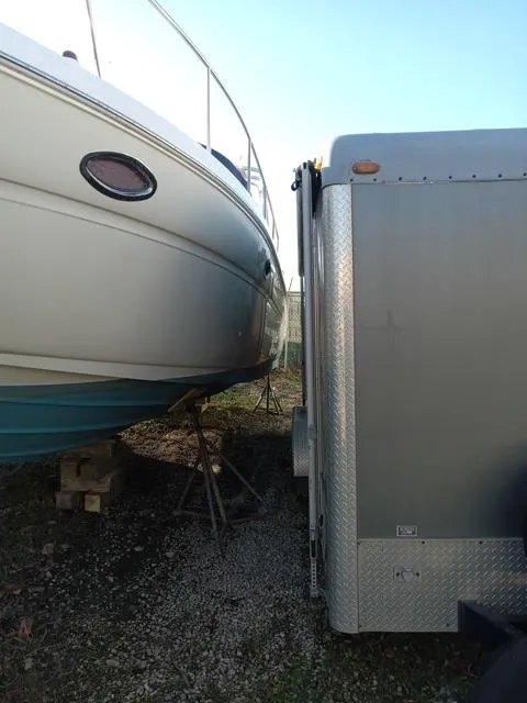 Slide: The Image of 2001 Sea Ray 290 Amberjack boat stored next to a trailer. - 24