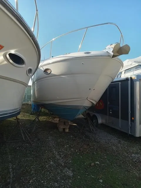 Slide: The Image of 2001 Sea Ray 290 Amberjack boat on dry dock between other vessels. - 25