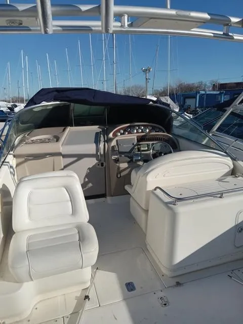 Slide: The Image of 2001 Sea Ray 290 Amberjack boat interior with white seating and control panel. - 3