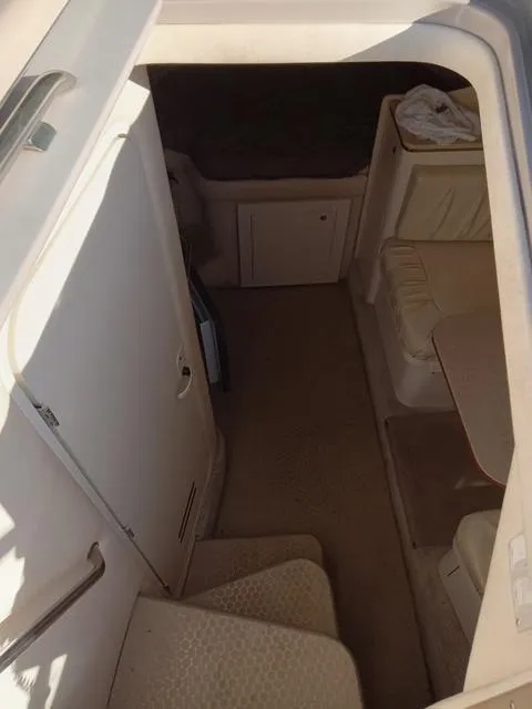 Slide: The Image of Interior cabin of 2001 Sea Ray 290 Amberjack boat with seating and storage. - 7