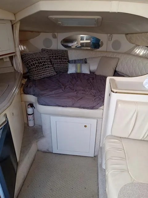 Slide: The Image of 2001 Sea Ray 290 Amberjack cabin interior with bed and seating area. - 8