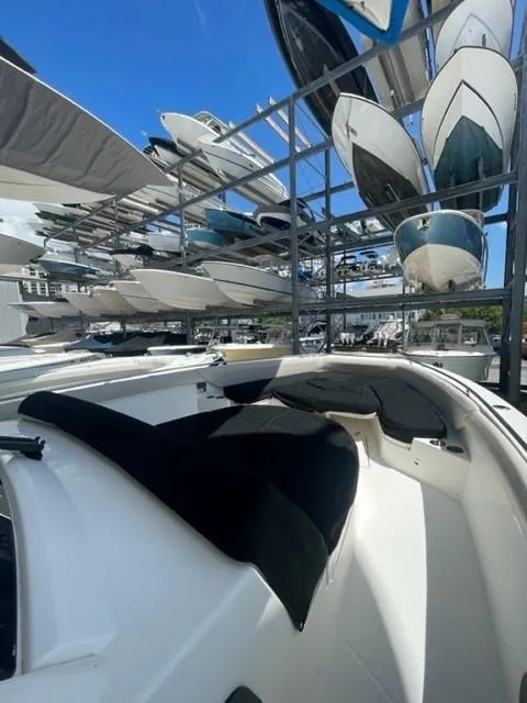 Slide: The Image of 2018 Boston Whaler 420 Outrage in marina storage, surrounded by other boats. - 17