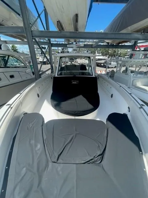 Slide: The Image of 2018 Boston Whaler 420 Outrage boat with covered seating, docked in a marina. - 19