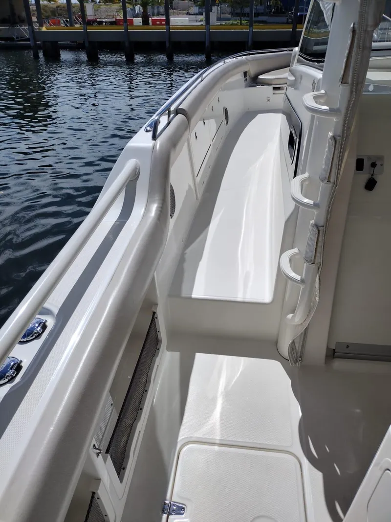 Slide: The Image of 2018 Boston Whaler 420 Outrage boat deck with sleek design and waterfront view. - 23