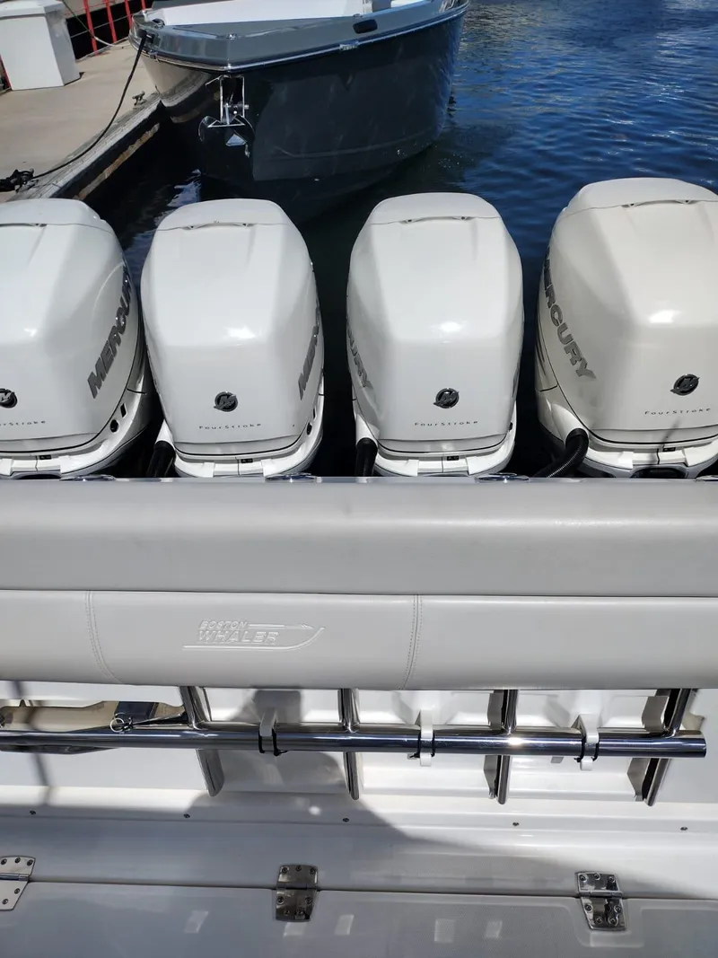 Slide: The Image of 2018 Boston Whaler 420 Outrage with four Mercury outboard engines at dock. - 25