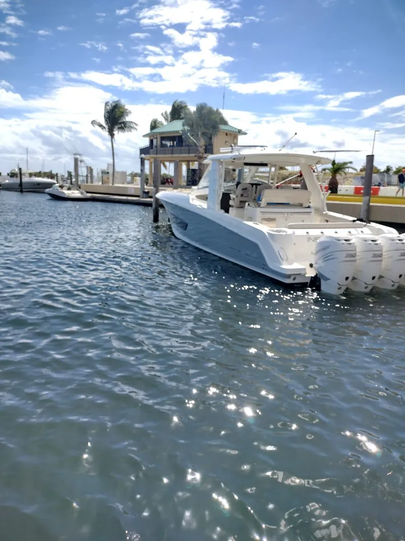 Slide: The Image of 2018 Boston Whaler 420 Outrage docked in sunny marina with palm trees. - 34